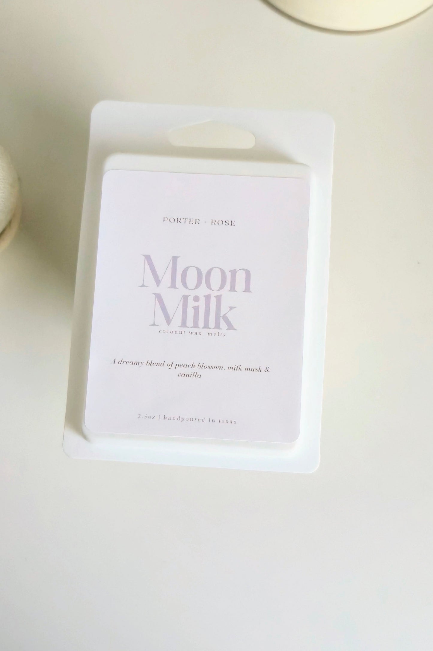 Moon Milk scented and toxin free wax melt packaging on a light surface