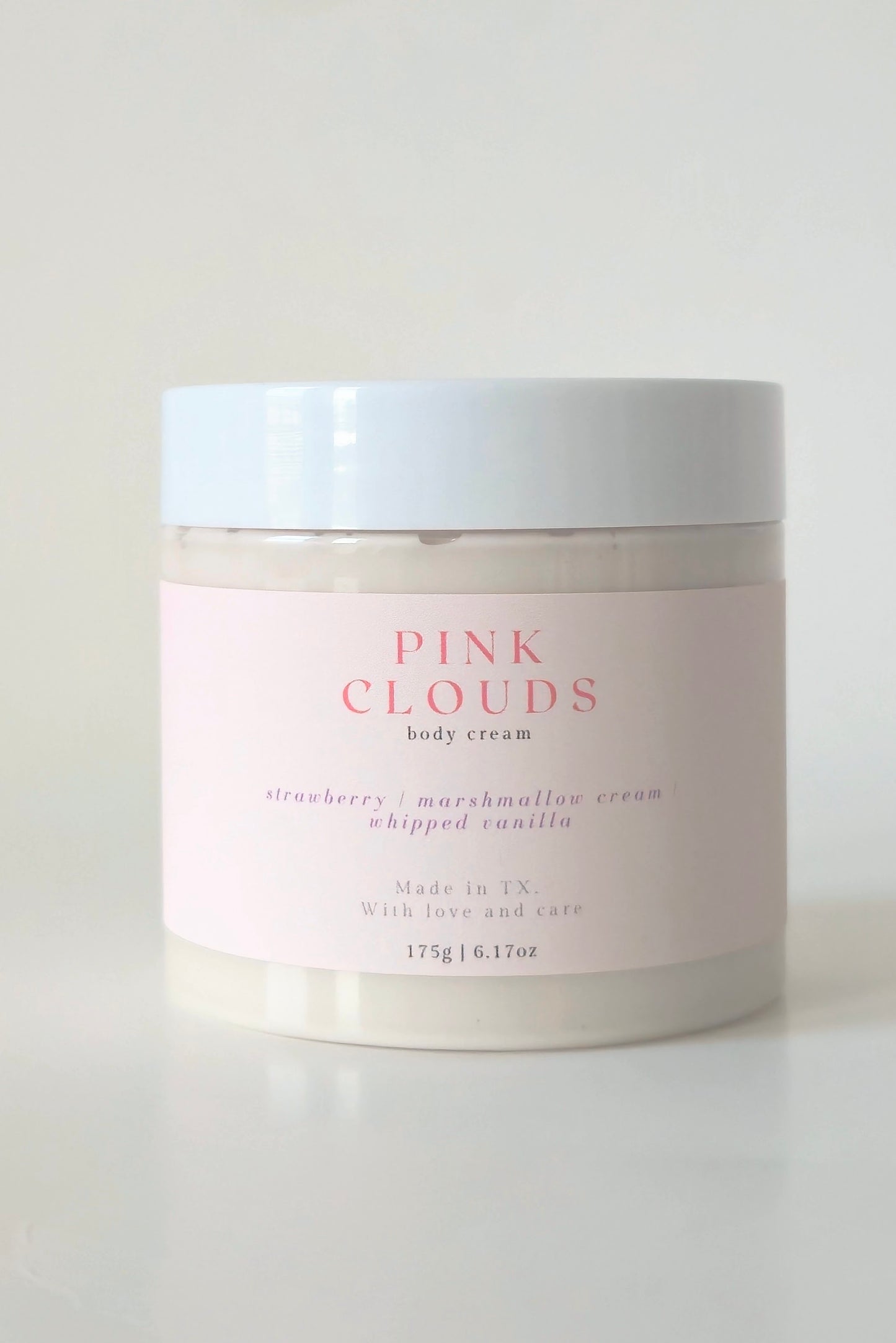 Pink Clouds body cream in a 175g plastic jar. A soft, whipped cream with notes of strawberry, marshmallow, and vanilla. Cute, girlie skincare.