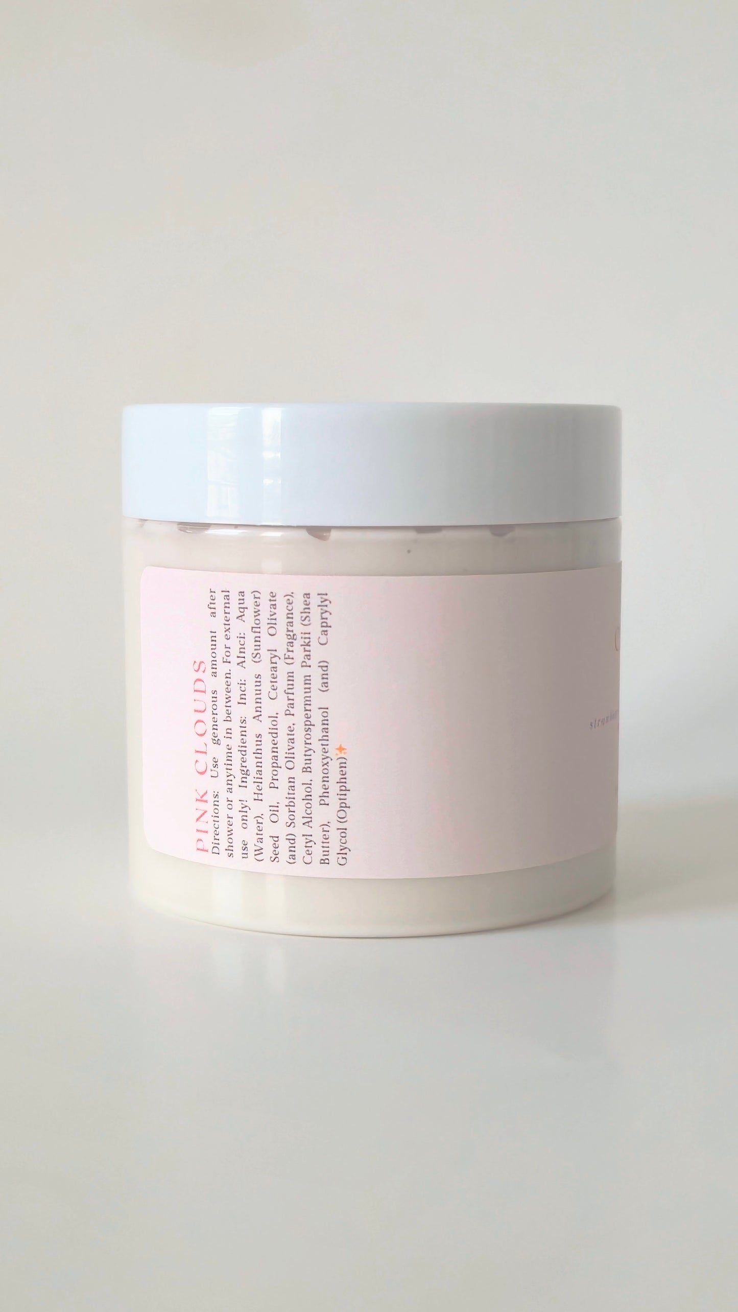 Pink Clouds body cream in a 175g plastic jar. A soft, whipped cream with notes of strawberry, marshmallow, and vanilla. Cute, girlie skincare.
