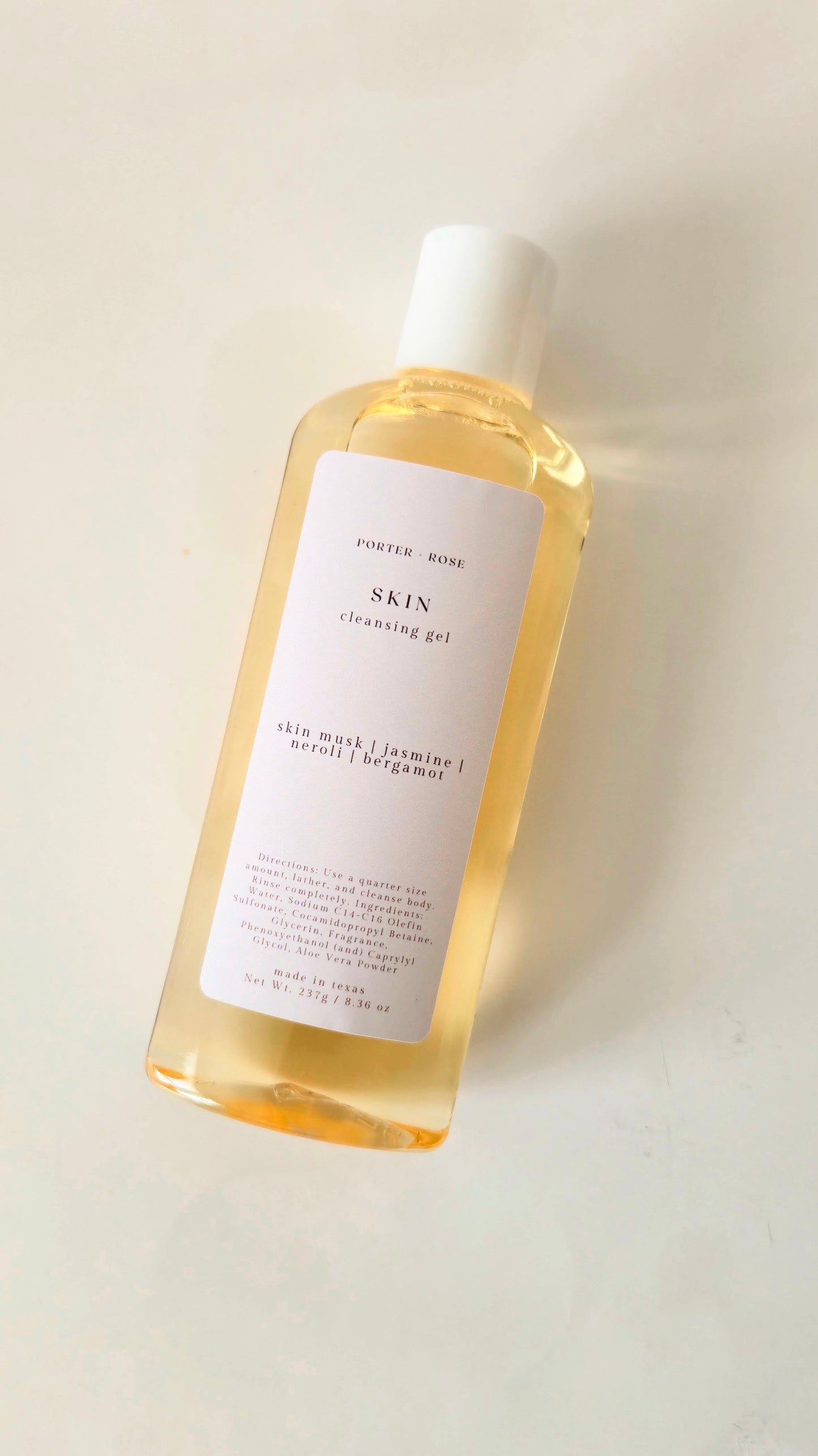 Bottle of 'SKIN' cleansing gel on a light background