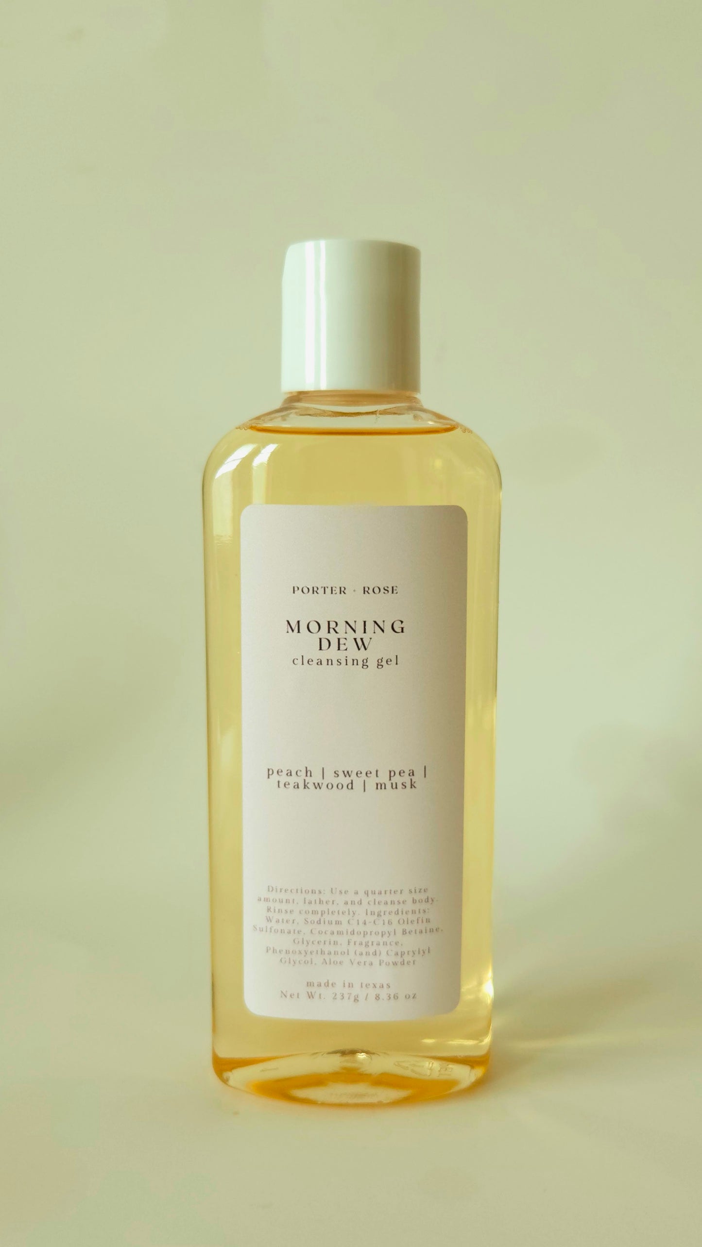 Bottle of 'Morning Dew' cleansing gel on a light green background