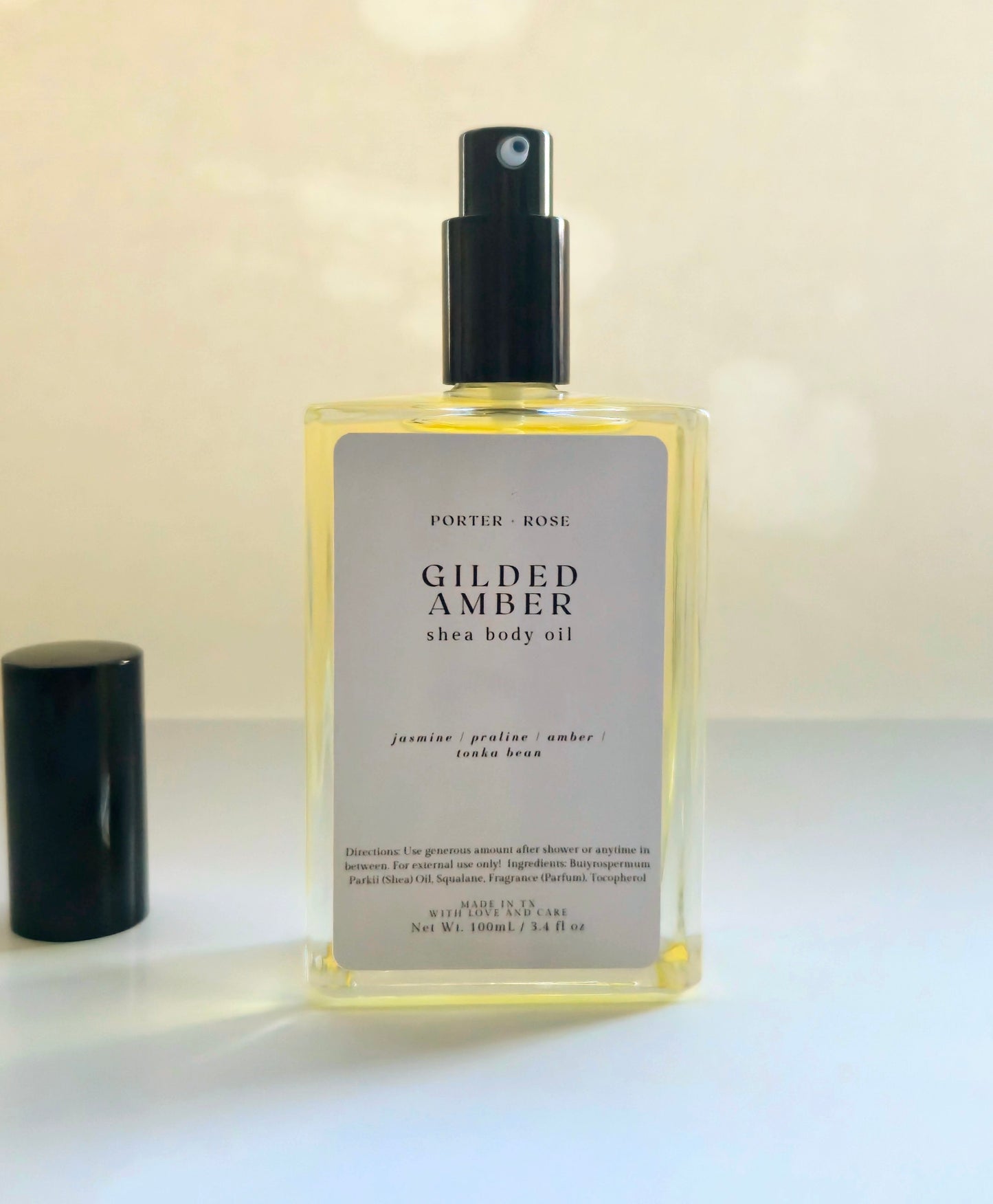 Gilded Amber Shea Body Oil for dry skin — medium-weight moisturizing oil with shea oil, squalane, and vitamin E. Nourishes and softens winter skin with a warm jasmine, praline, and amber scent.