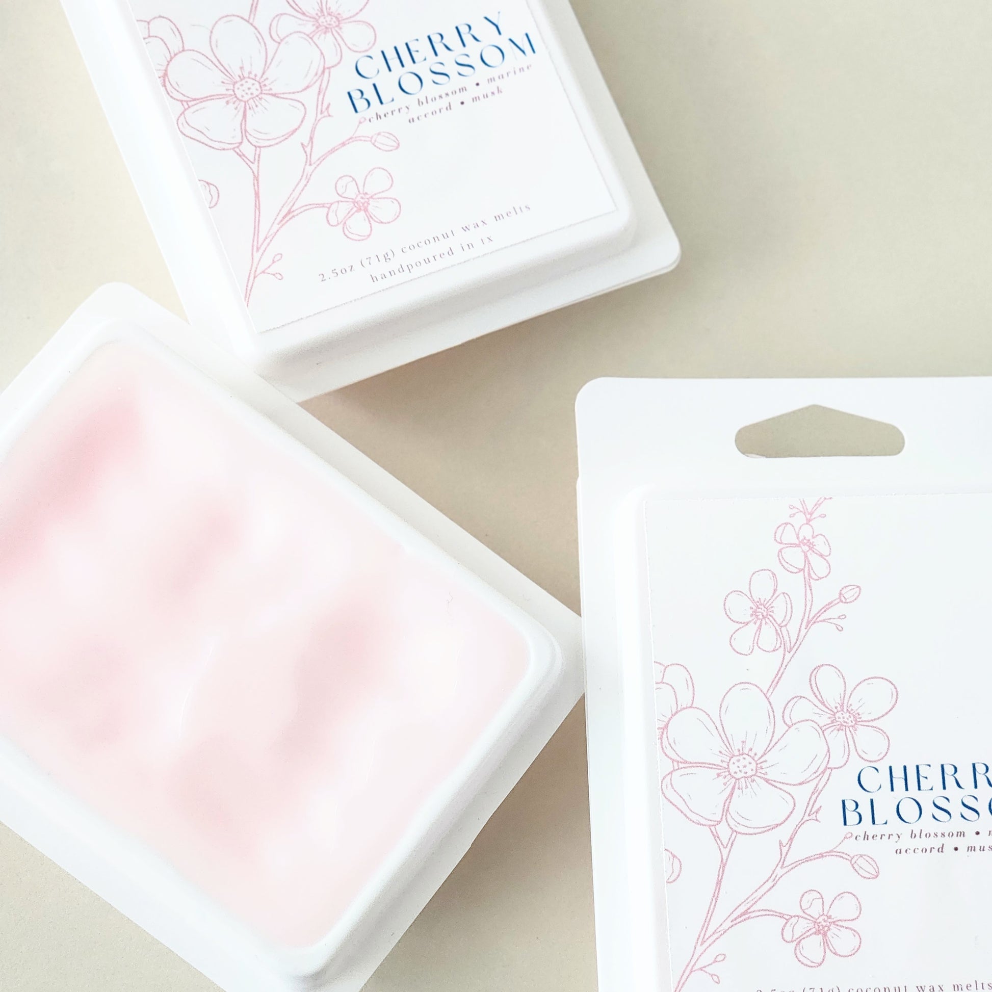 Six hand-poured cherry blossom wax melts packaged in a sleek white clamshell container. Limited edition spring fragrance for home.