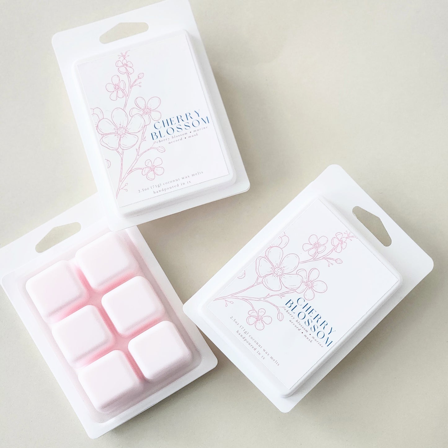 Six hand-poured cherry blossom wax melts packaged in a sleek white clamshell container. Limited edition spring fragrance for home.