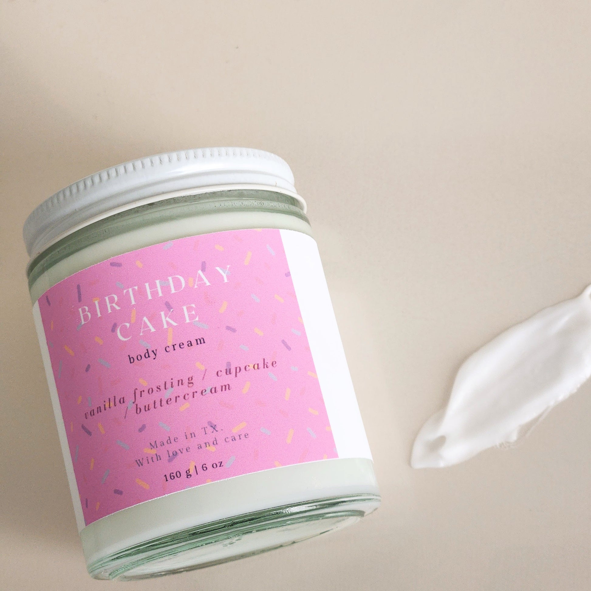 birthday cake body cream in clear glass heavy bottomed jar, 160g - sprinkle label pink - porter + rose