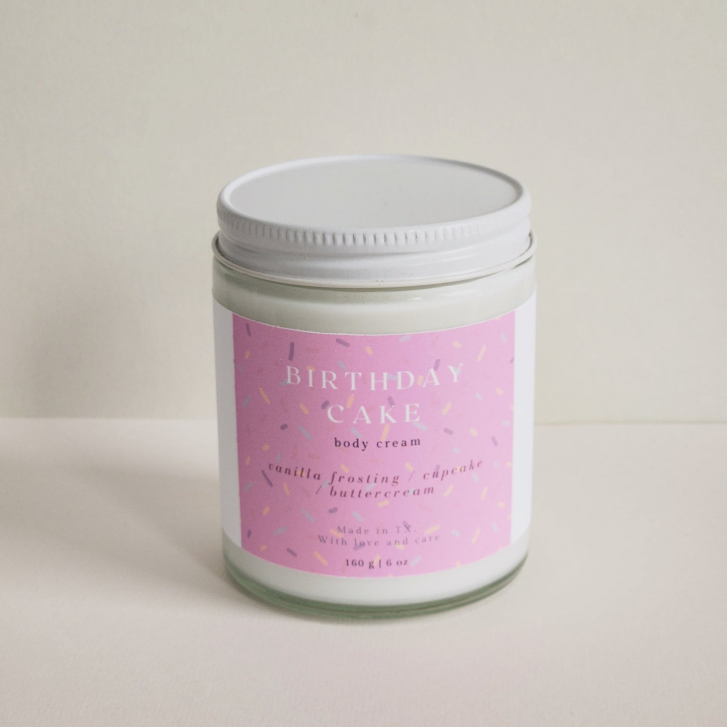 birthday cake body cream in clear glass heavy bottomed jar, 160g - sprinkle label pink - porter + rose