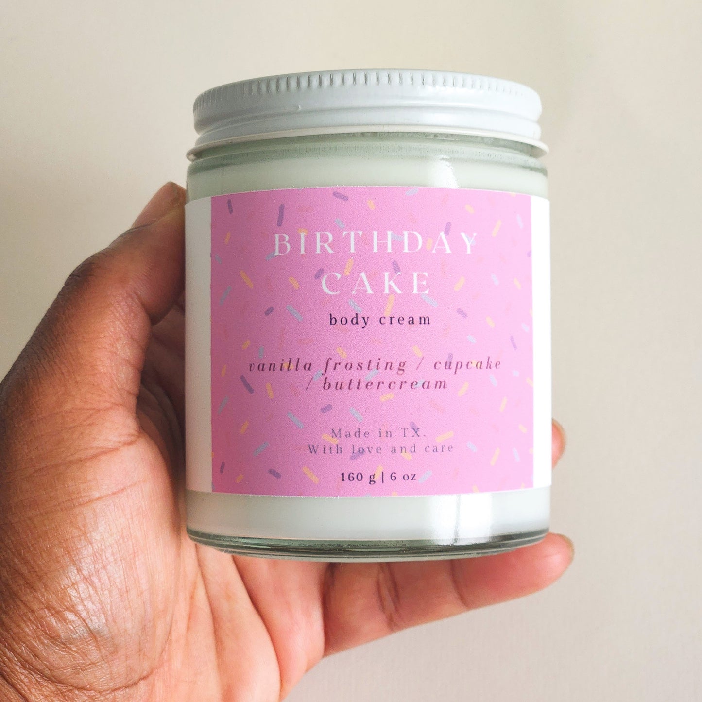 birthday cake body cream in clear glass heavy bottomed jar, 160g - sprinkle label pink - porter + rose