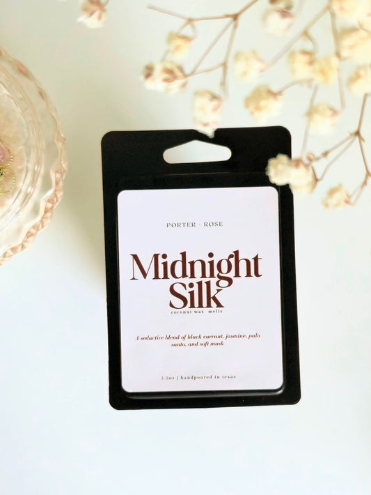  'Midnight Silk' wax melts with perfume oil on a light background with decorative elements.