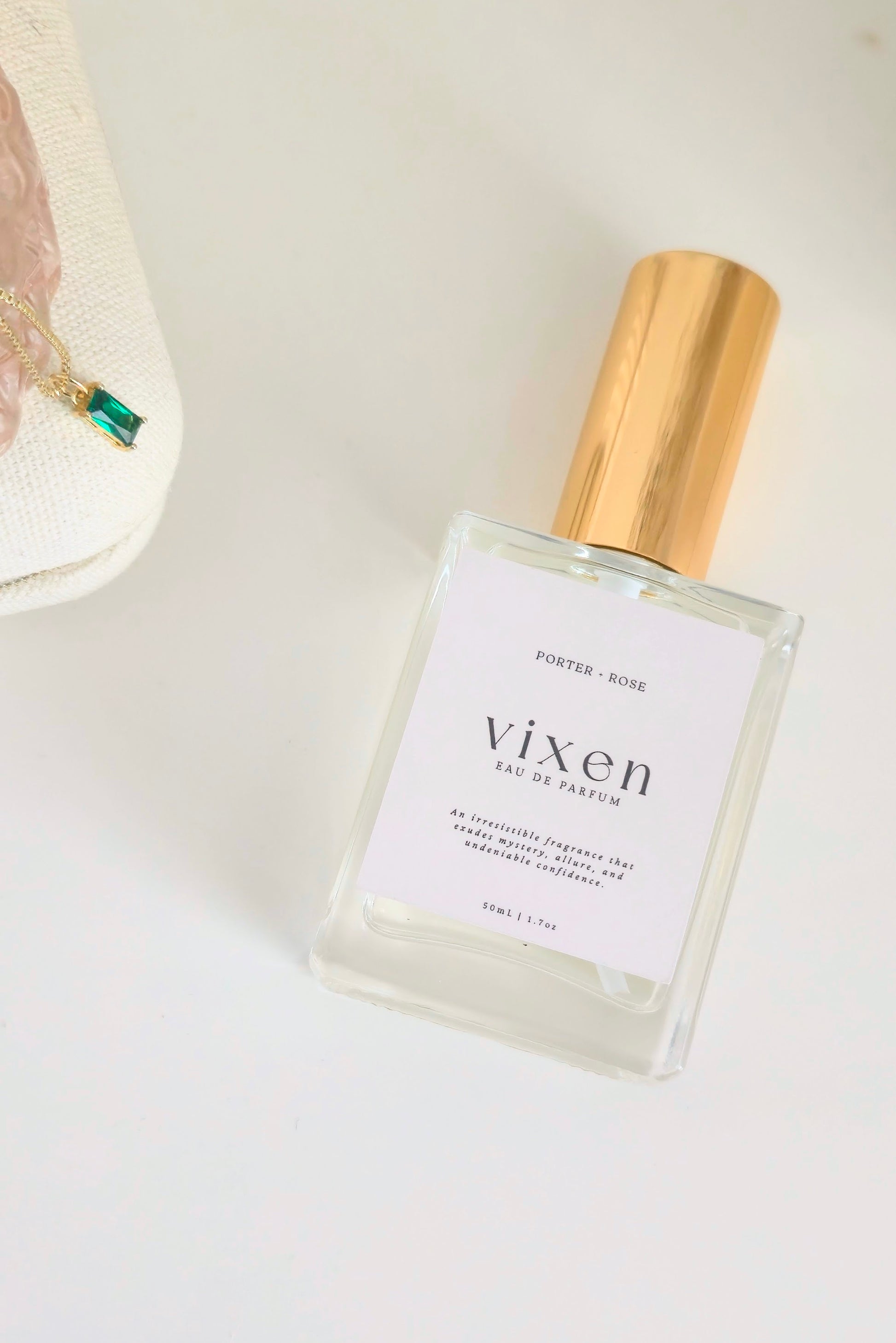 Perfume bottle labeled 'vixen' on a light background