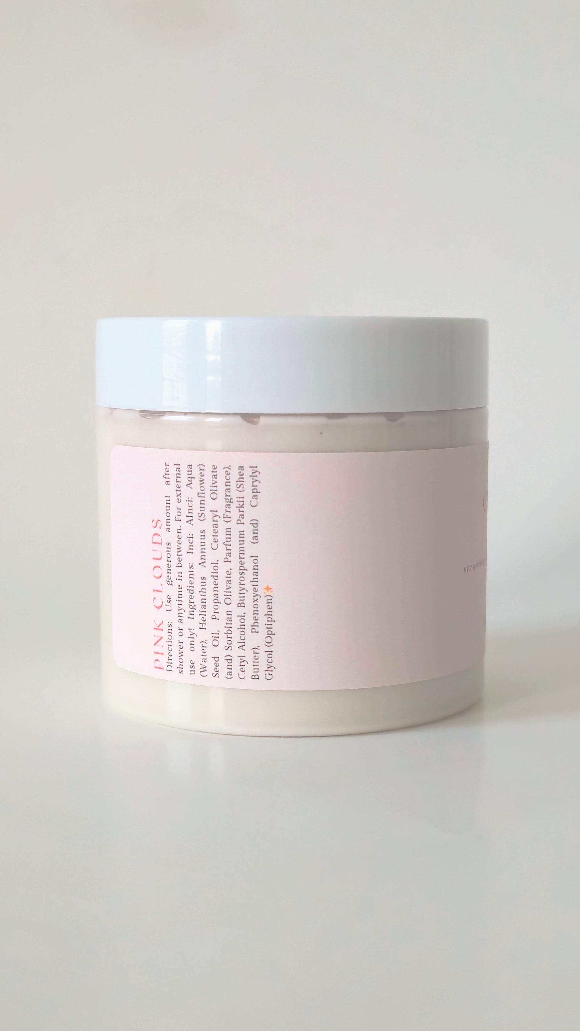 Pink Clouds body cream in a 175g plastic jar. A soft, whipped cream with notes of strawberry, marshmallow, and vanilla. Cute, girlie skincare.