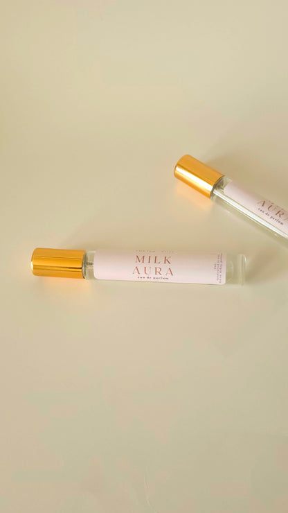 Two 'Milk Aura' eau de parfums tubes on a beige background