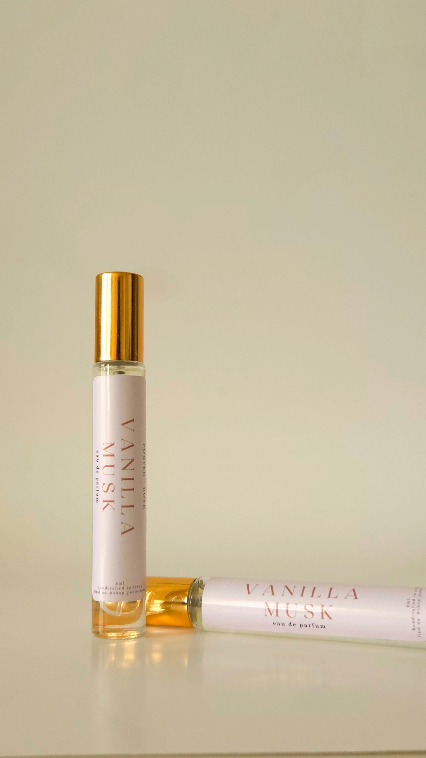 Two Vanilla Musk perfume bottles on a beige background