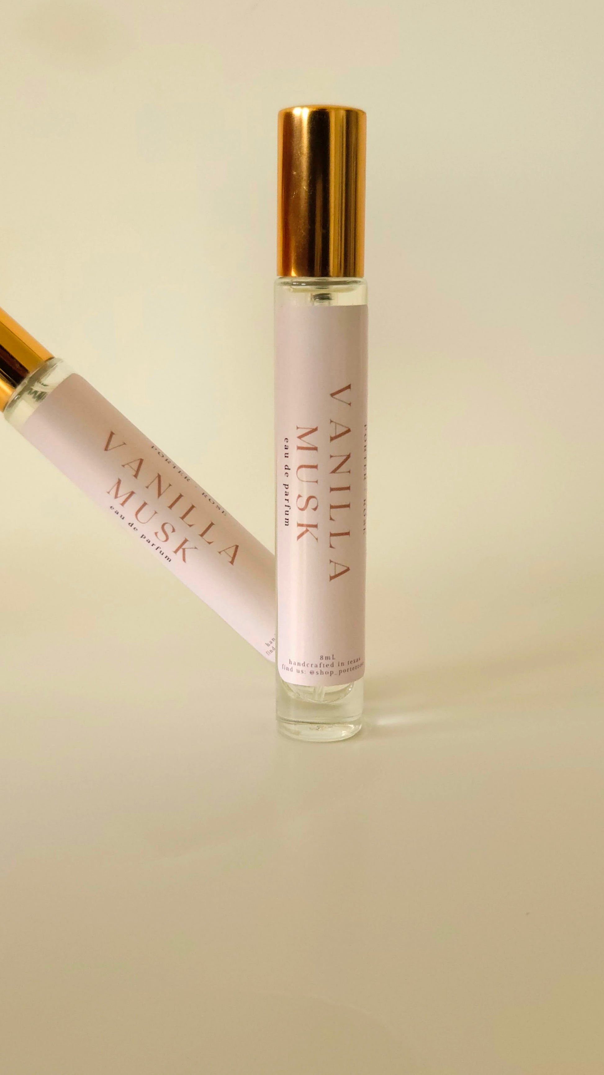 Two Vanilla Musk perfume bottles on a beige background