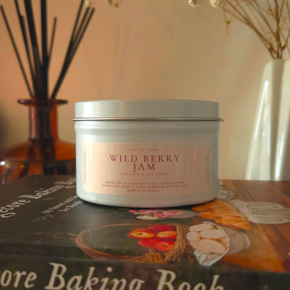 Wild Berry Jam dessert candle with wooden wick glowing on an autumn-decorated mantle