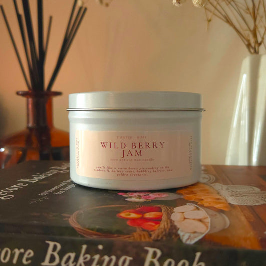 Wild Berry Jam dessert candle with wooden wick glowing on an autumn-decorated mantle