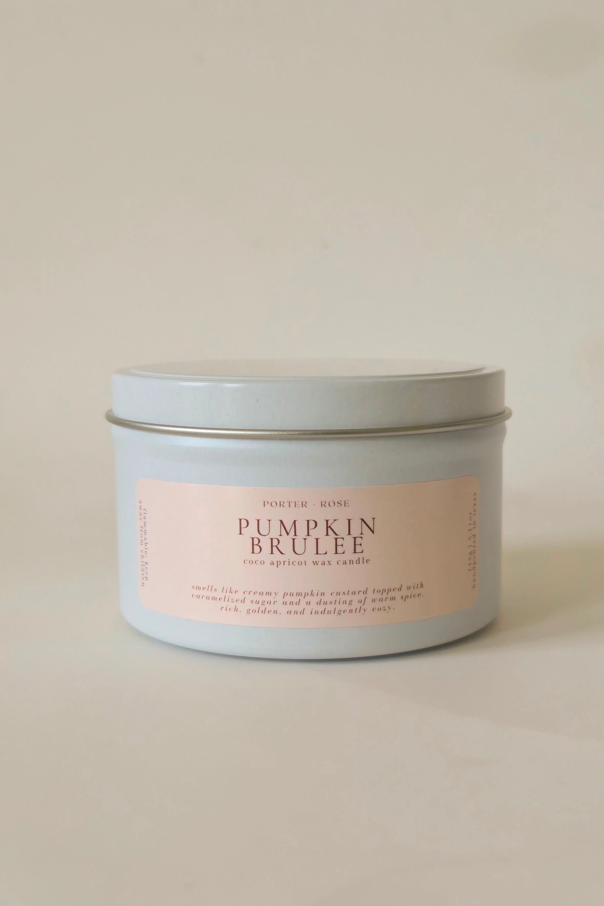 Pumpkin Brulee wooden wick candle in a white tin jar, 5oz size, with clean white background.