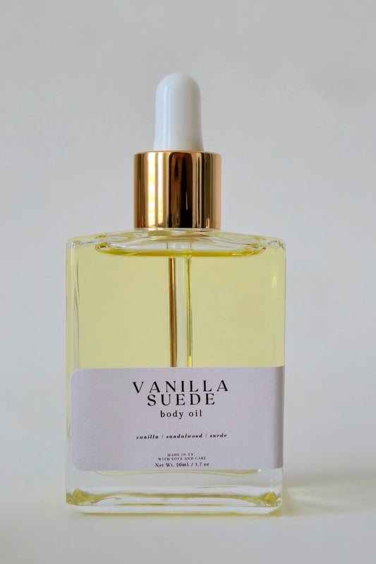 Vanilla Suede body oil bottle with dropper on a white background