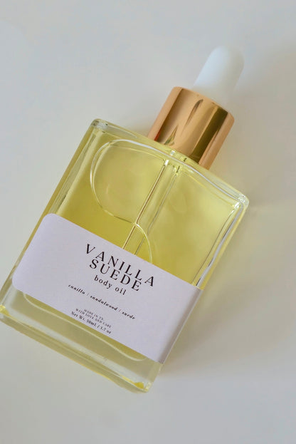 Vanilla Suede body oil bottle with dropper on a white background