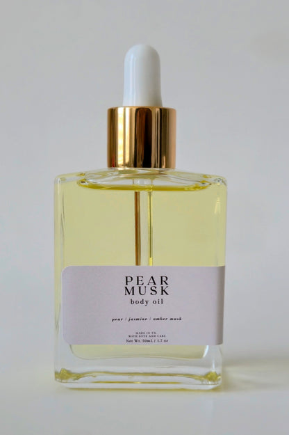 Pear Musk body oil bottle with dropper on a white background