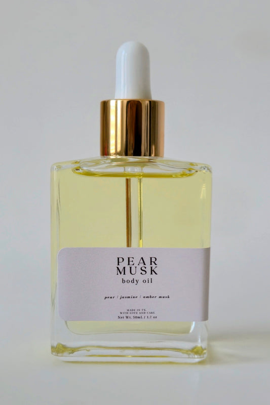 Pear Musk body oil bottle with dropper on a white background