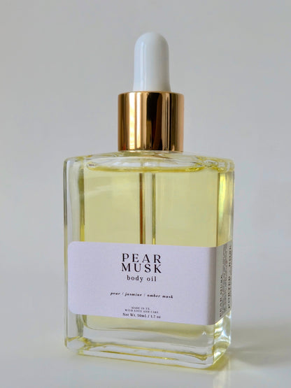 Bottle of Pear Musk body oil on a light gray background