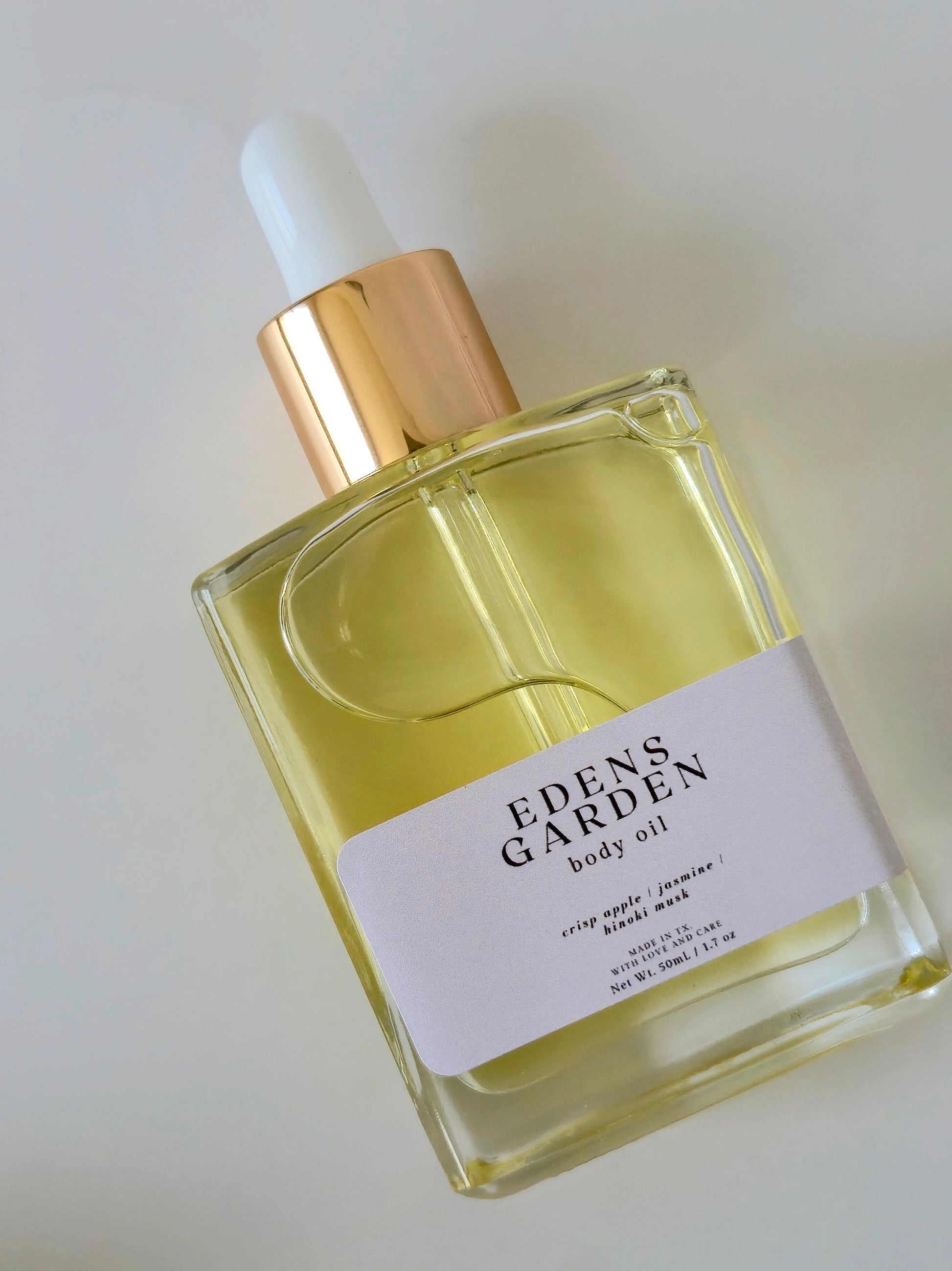 Eden's Garden body oil bottle on a light background