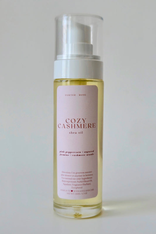Cozy Cashmere shea body oil bottle on a white background