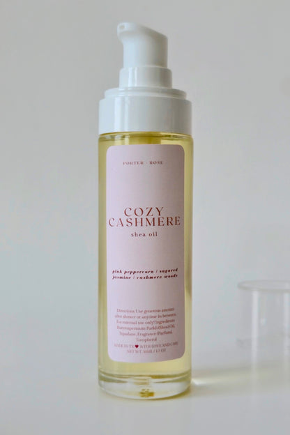 Bottle of Cozy Cashmere shea oil on a light background