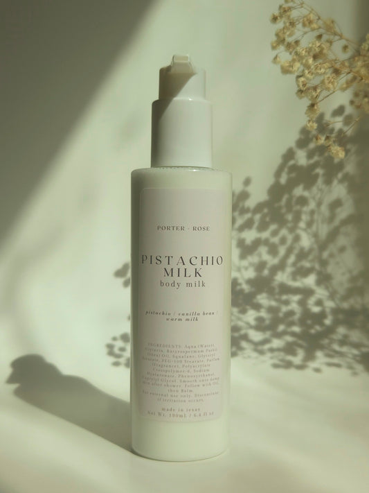 Pistachio Milk body milk bottle on a neutral background with soft shadows