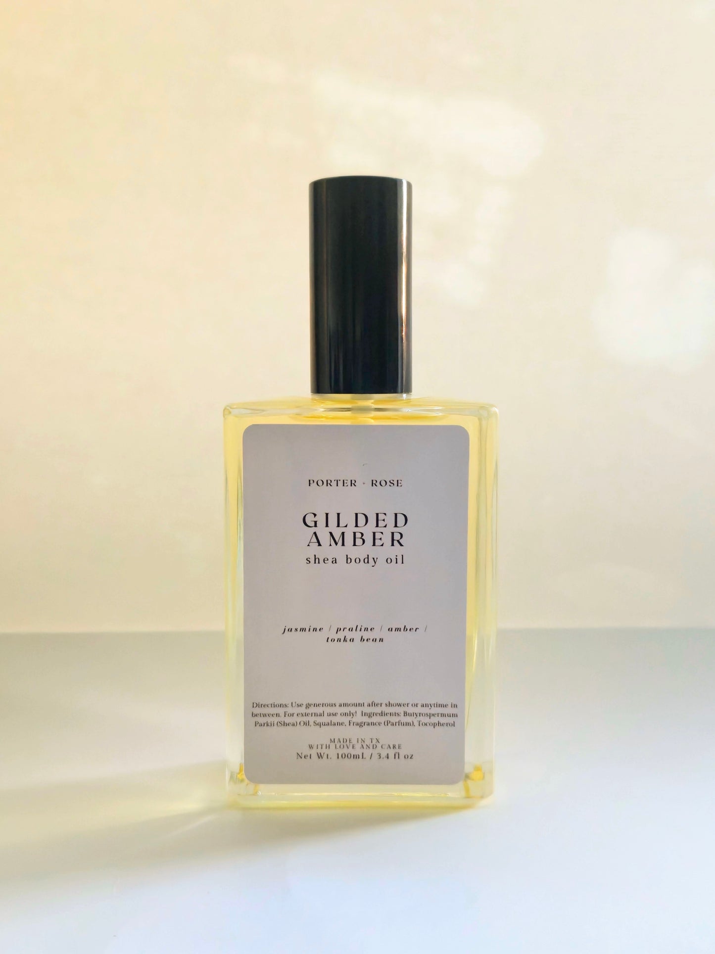Gilded Amber Shea Body Oil for dry skin — medium-weight moisturizing oil with shea oil, squalane, and vitamin E. Nourishes and softens winter skin with a warm jasmine, praline, and amber scent.