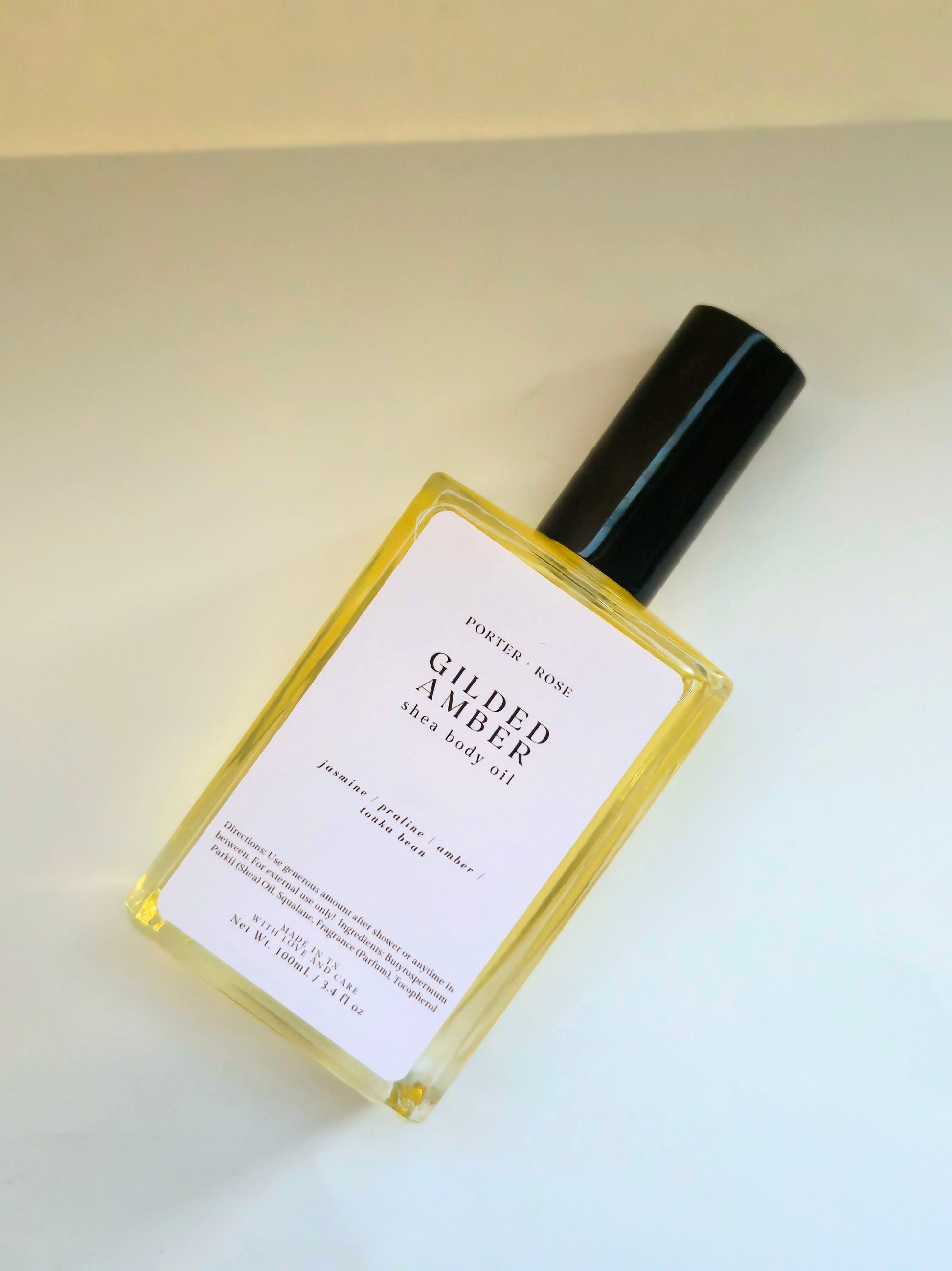 Gilded Amber Shea Body Oil for dry skin — medium-weight moisturizing oil with shea oil, squalane, and vitamin E. Nourishes and softens winter skin with a warm jasmine, praline, and amber scent.