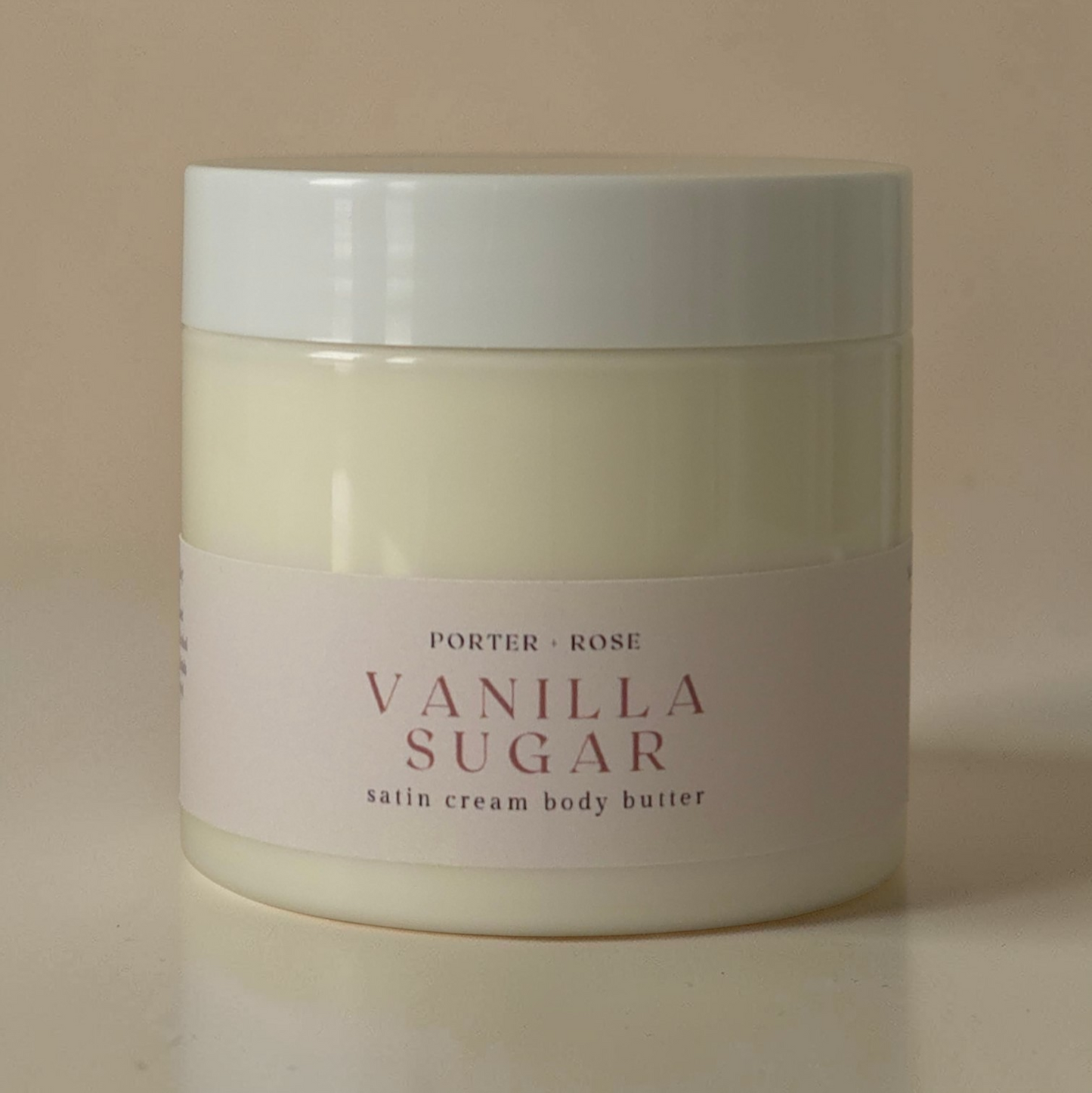 Jar of Porter & Rose Vanilla Sugar satin cream body butter on a beige background