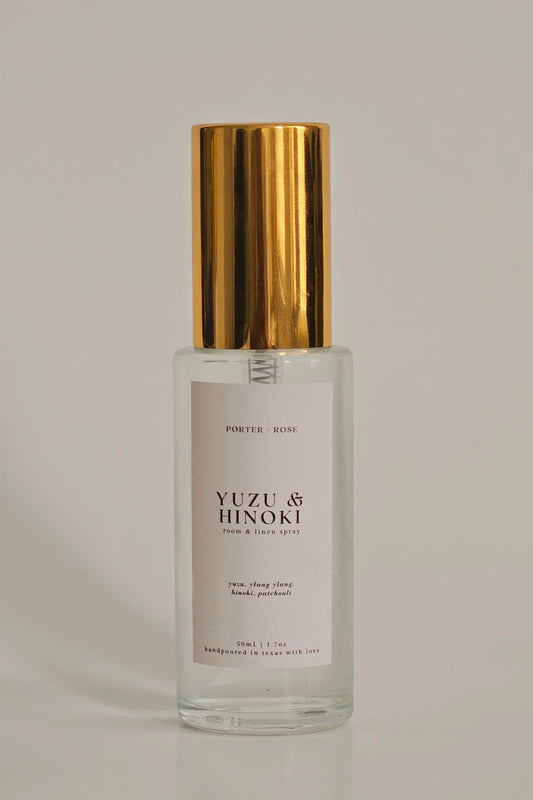 Clear glass bottle with gold cap on a gray background