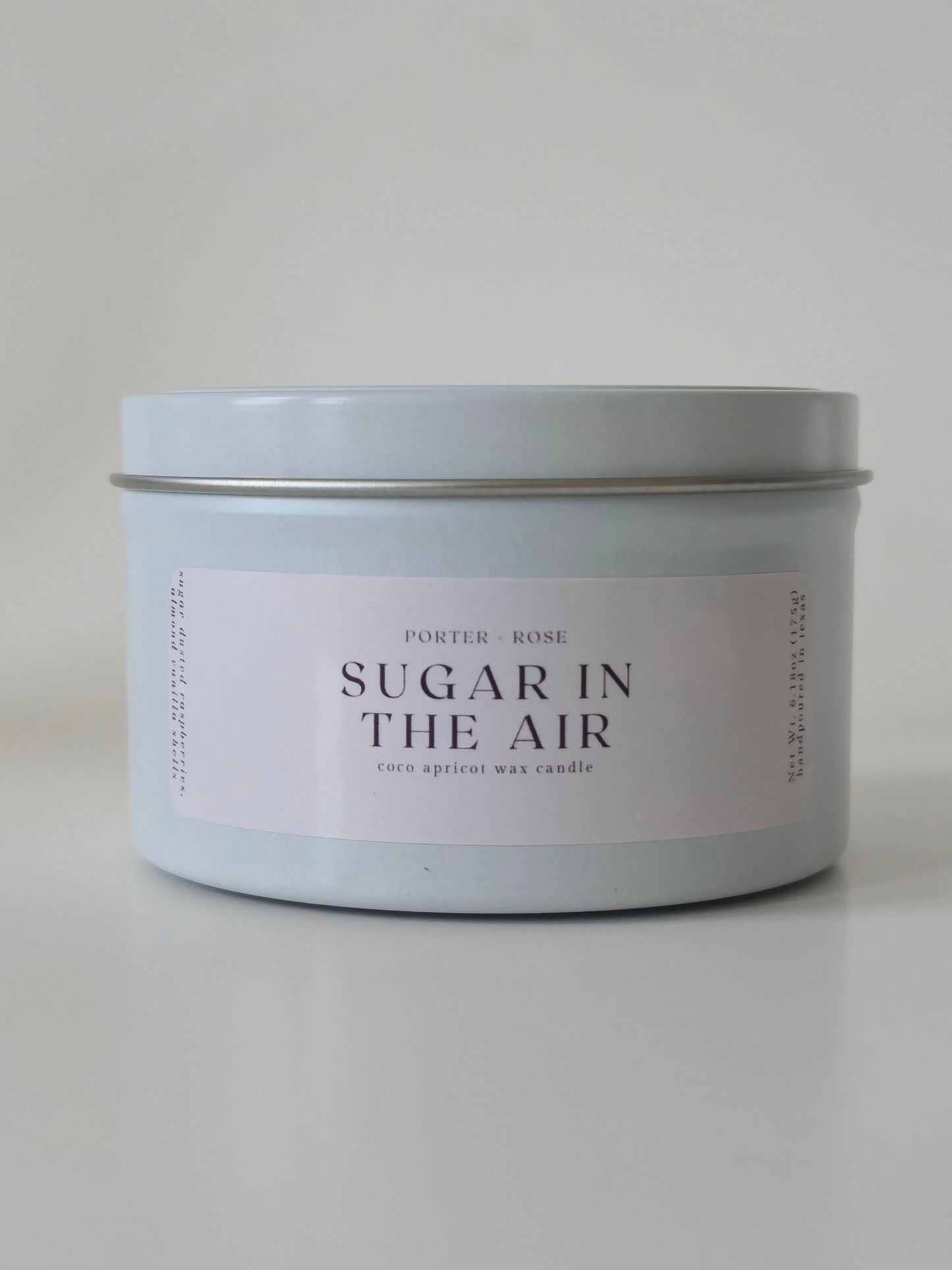 White Metal Tin 'Sugar in the Air' Candle on a light gray background
