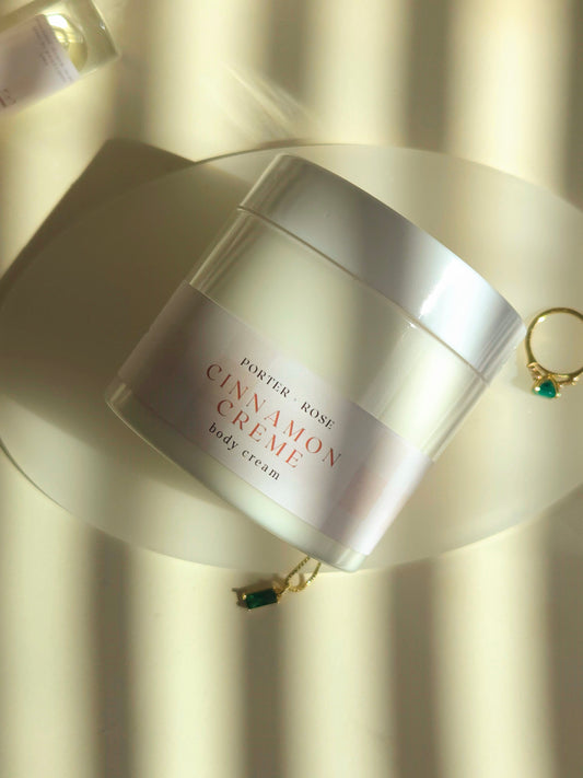 Cinnamon body cream with fall styling and cozy aesthetic