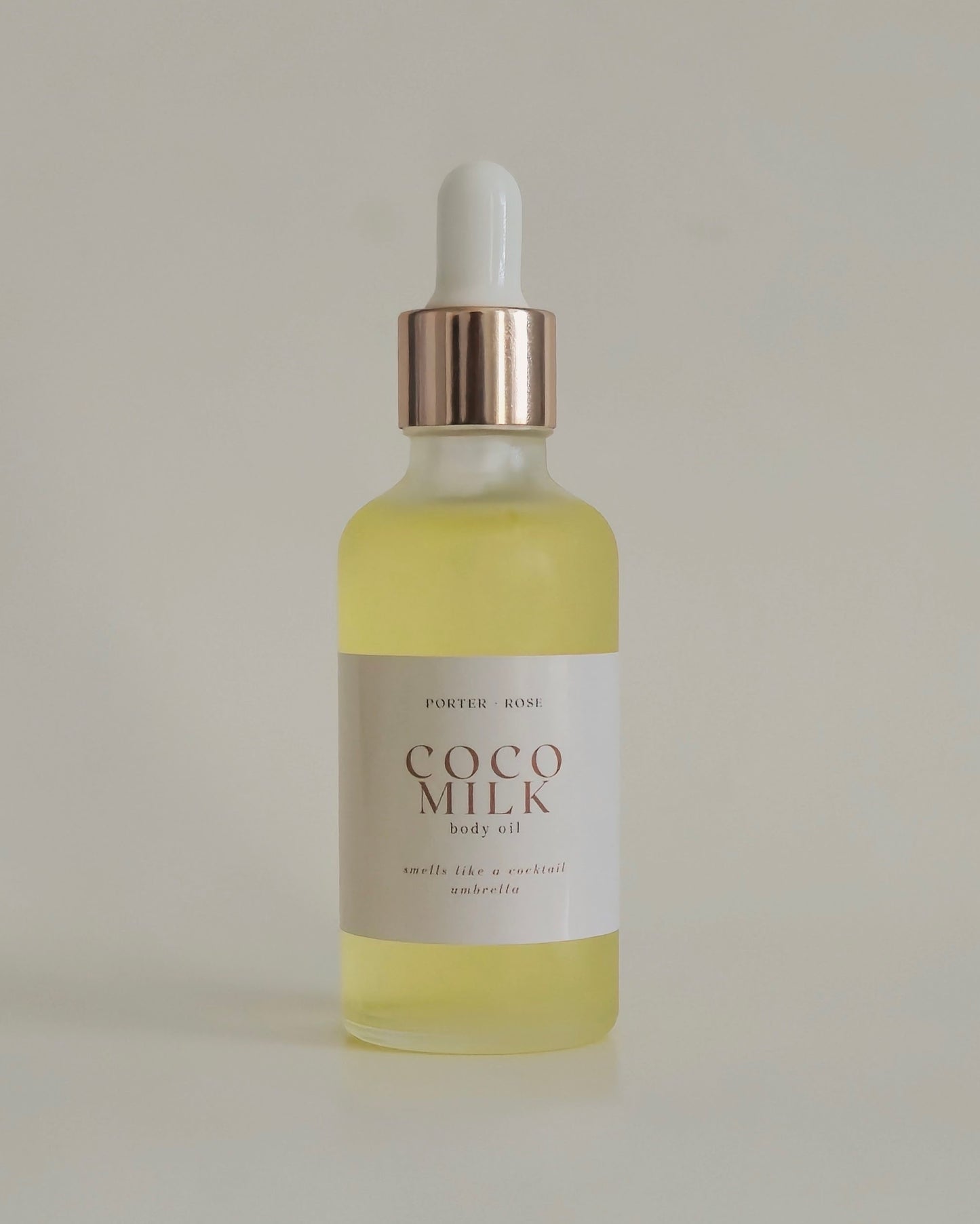 glass bottle dropper of golden body oil Coco Milk by porter rose