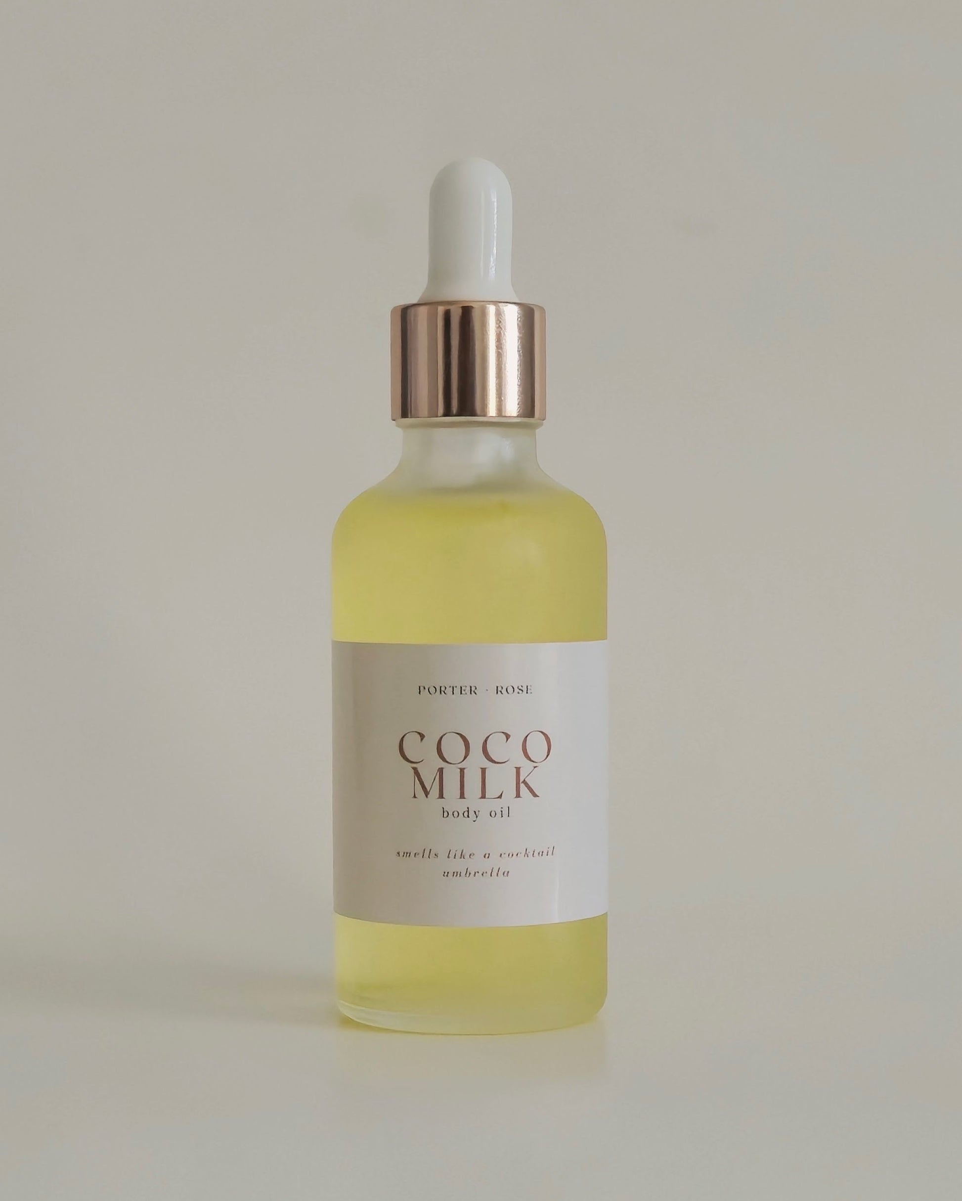 glass bottle dropper of golden body oil Coco Milk by porter rose