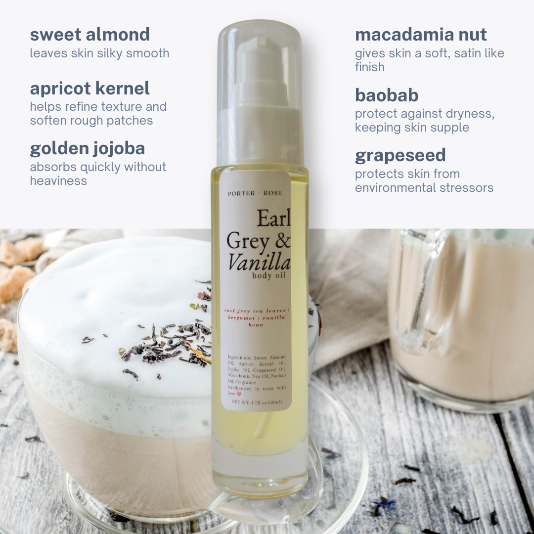 A bottle of Porter Rose Earl Grey & Vanilla body oil centered on a rustic wooden surface, with a cup of latte and dried botanicals in the background. Text callouts describe scent notes: sweet almond, apricot kernel, golden jojoba, macadamia nut, baobab, and grapeseed.