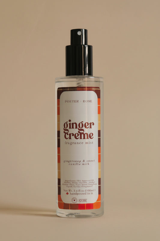 A bottle of porter rose Ginger Creme Fragrance Oil, featuring a clear bottle with a black spray nozzle and a white label with orange and brown accents, set against a plain light background.