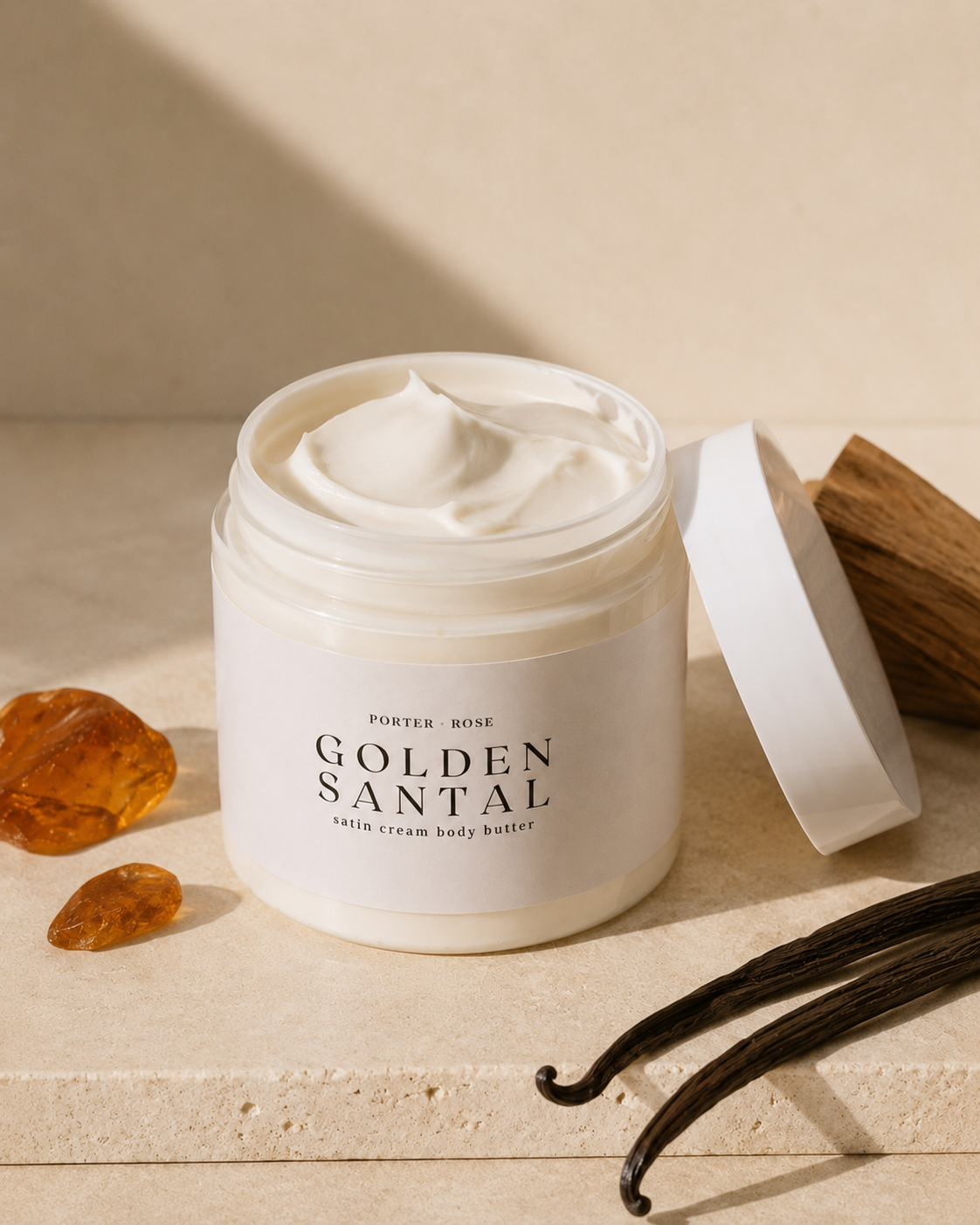 jar of golden santal body butter texture on stone riser - sandalwood, amber, vanilla