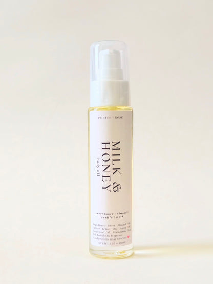 A clear bottle of Porter Rose Milk & Honey body oil with a white pump dispenser, set against a plain off-white background.