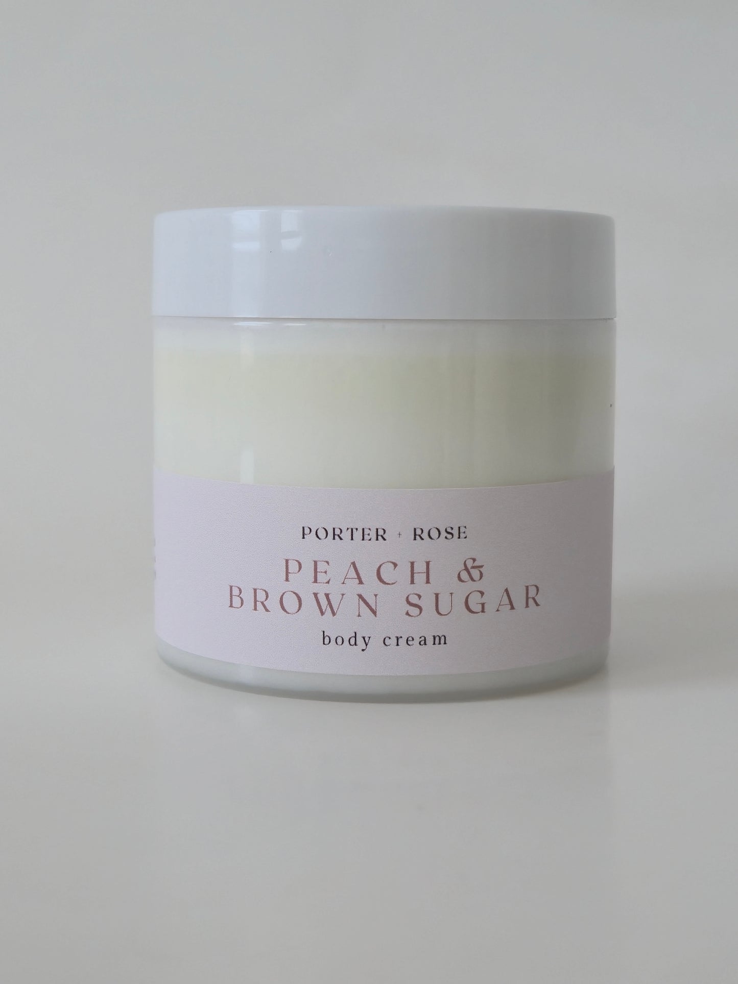 peach and brown sugar body cream lotion on white background
