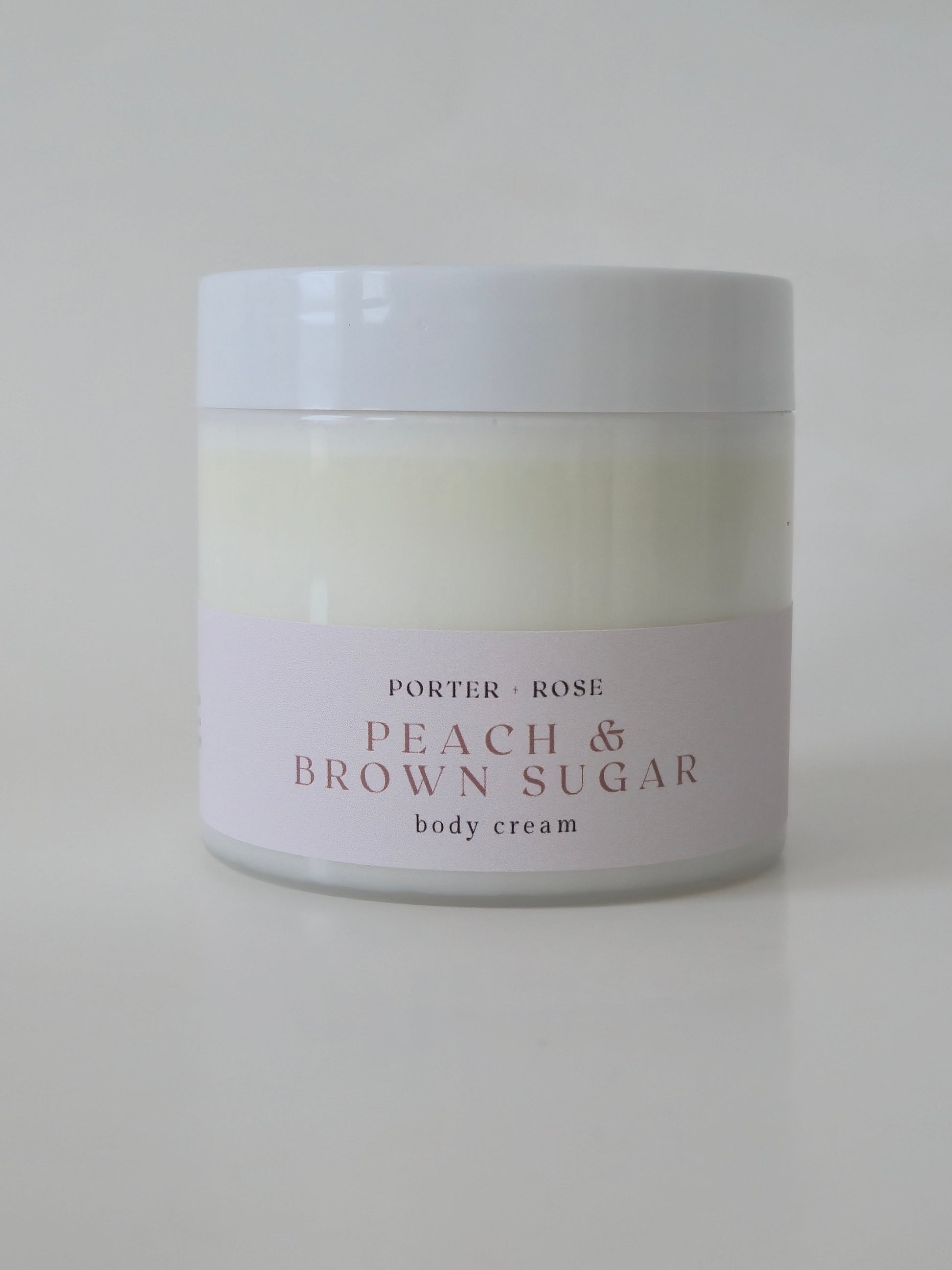 peach and brown sugar body cream lotion on white background