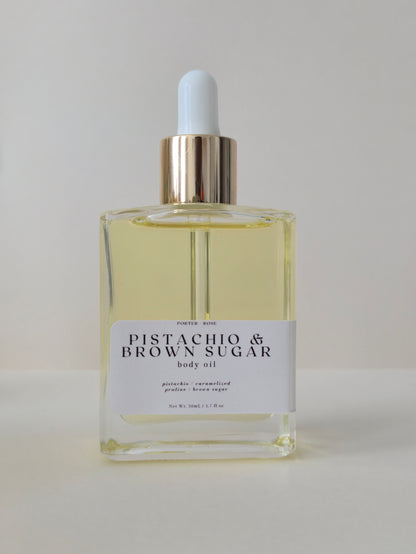 Bottle of Pistachio & Brown Sugar body oil on a light gray background