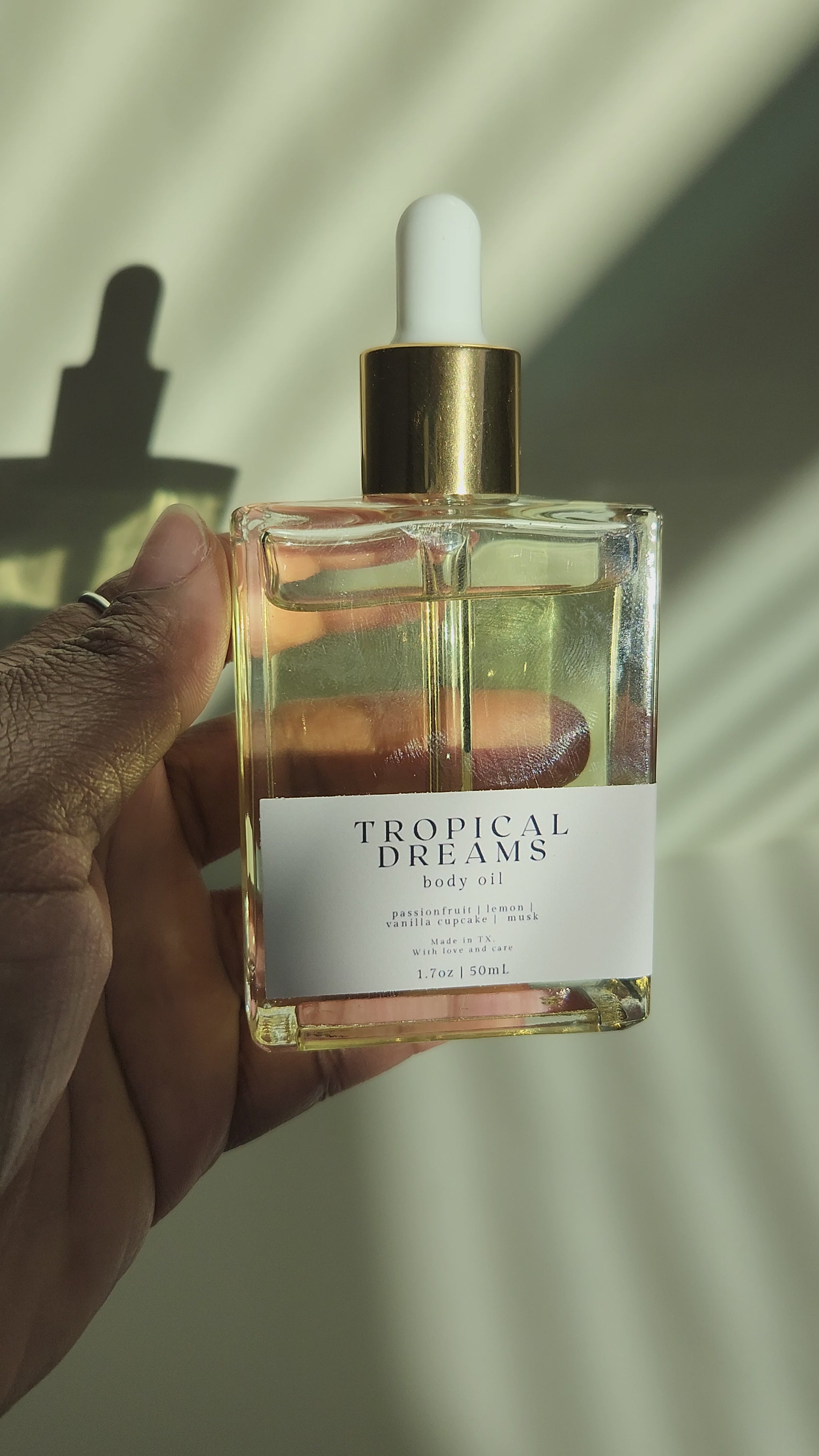 Tropical Dreams body oil for dry skin video - gold rimmed glass dropper bottle - porter + rose