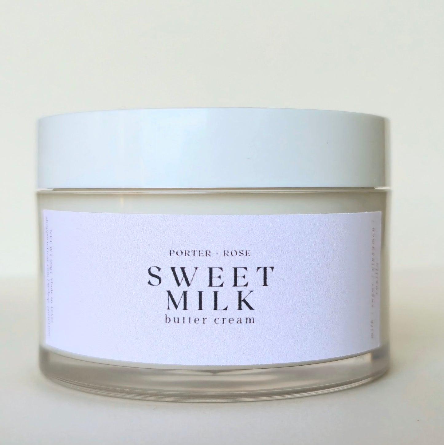 Jar of 'Sweet Milk' body butter cream with a white label on a beige background