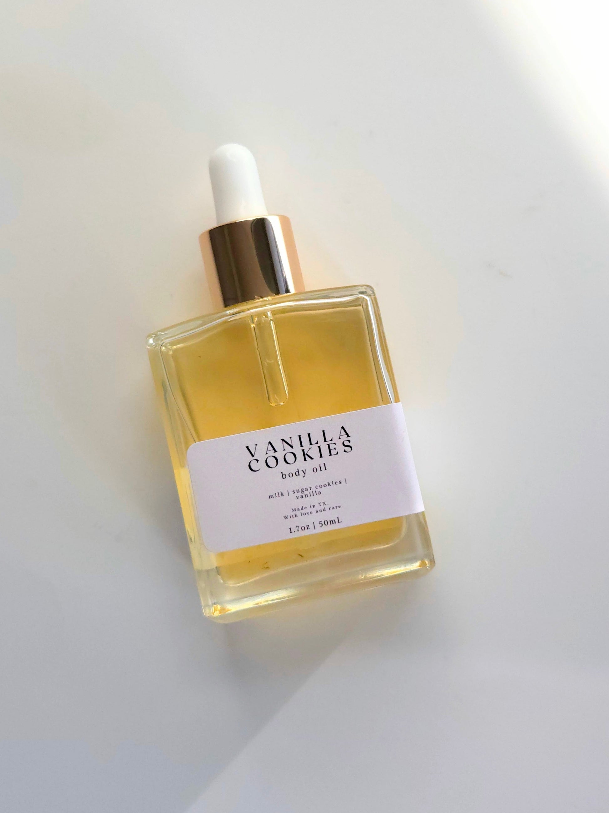Vanilla Cookies body oil bottle on a white background