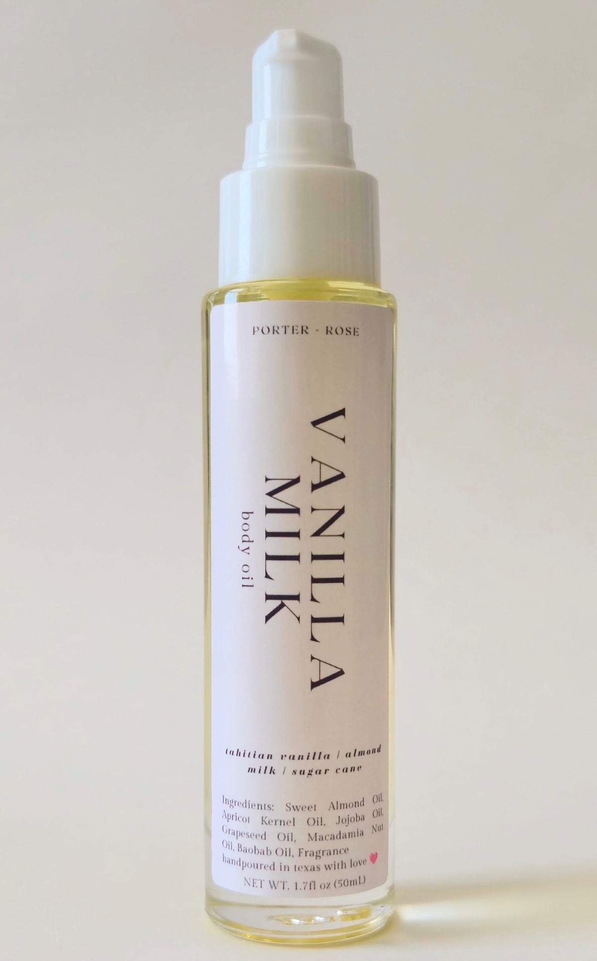 A bottle of Porter Rose Vanilla Milk body oil with a white pump dispenser and a white label, set against a plain off-white background.