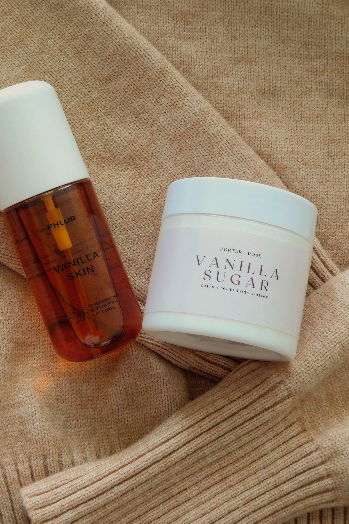 Two skincare products from Porter Rose body care arranged on a beige knit blanket: a small amber bottle labeled Vanilla Skin and a white jar labeled Vanilla Sugar.